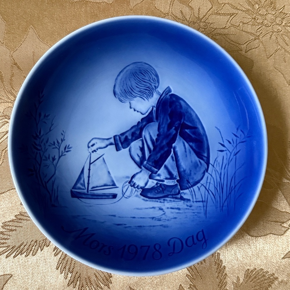 Blue Decorative Plate with Boy and Boat Design